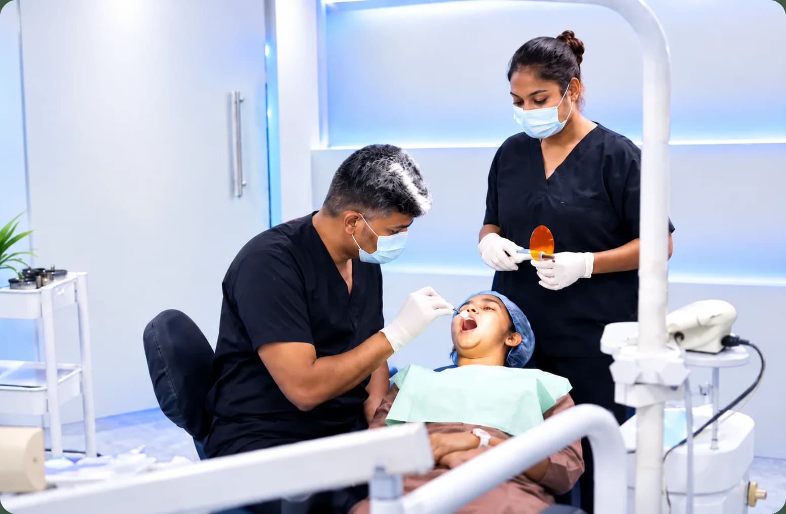 Dentists treating a patient at The Swish Dentistry